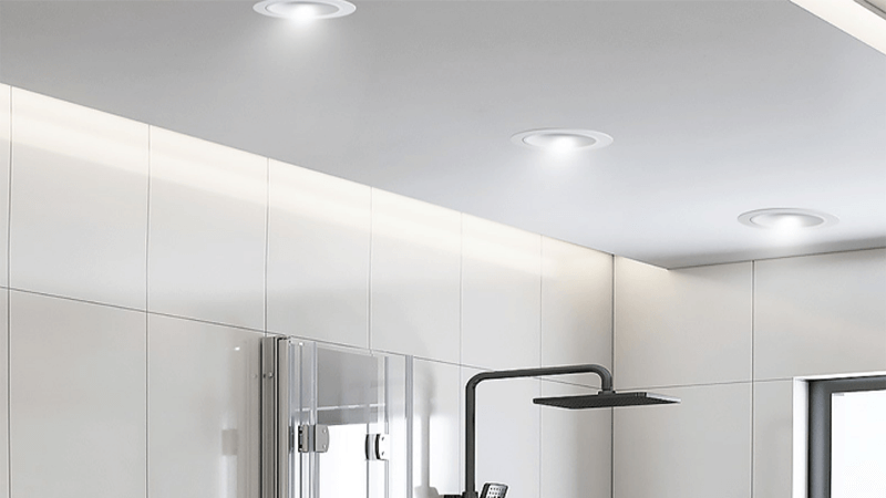 Checking the Downlight Driver in a Ceiling Void An electrician checking a driver in the ceiling void