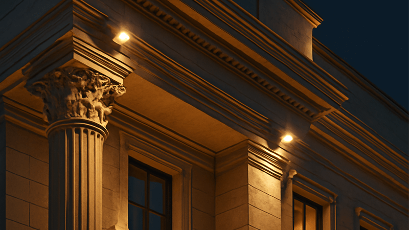 A modern commercial building facade beautifully lit with LED floodlights at night