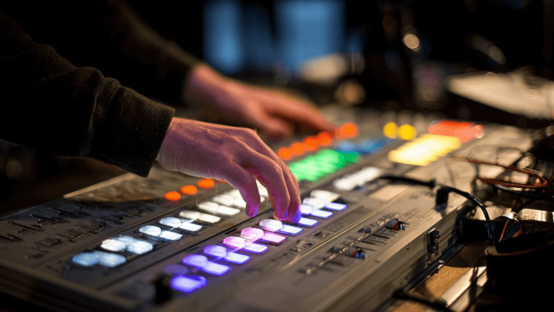 DMX Color Mixing Control A DMX lighting control board with faders being adjusted.