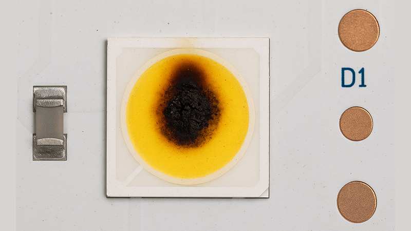 A burnt-out LED chip on a circuit board