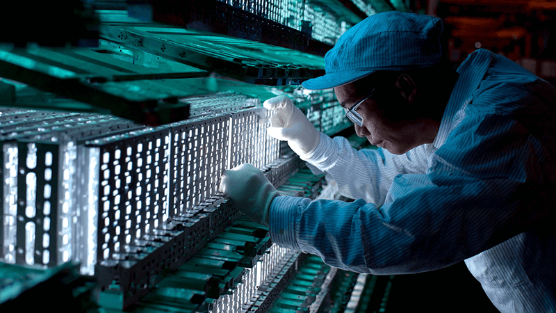 A technician inspecting an LED floodlight heat sink