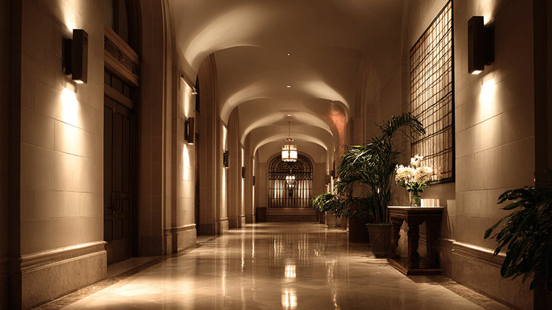 An example of elegant hotel lighting, with soft, focused beams highlighting architectural details without any glare