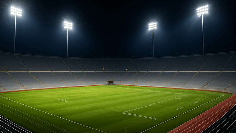 A wide view of a sports stadium brightly illuminated by LED floodlights