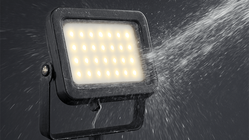 An LED floodlight being tested with water jets to determine its IP rating