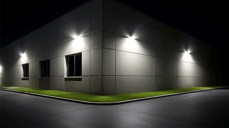 Security Benefits of LED Floodlights A well-lit commercial building perimeter with LED floodlights at night