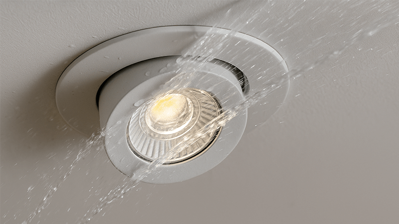 a downlight being sprayed with water to test its IP rating