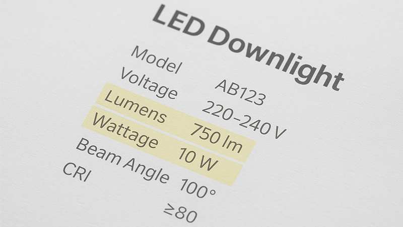 A close-up of an LED downlight's specification sheet with the lumens and wattage values highlighted.