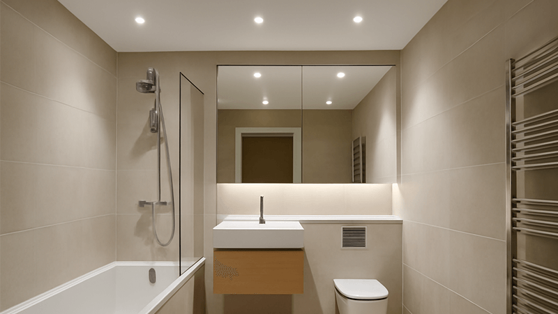 A modern bathroom illuminated by sleek recessed downlights.