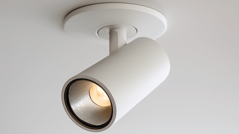 A close-up of a spotlight fixture, showing its narrow lens and adjustable head.