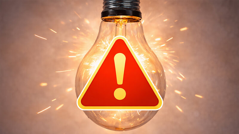 Warning: Do Not Dim a Non-Dimmable Light A flickering light bulb with a warning symbol over it